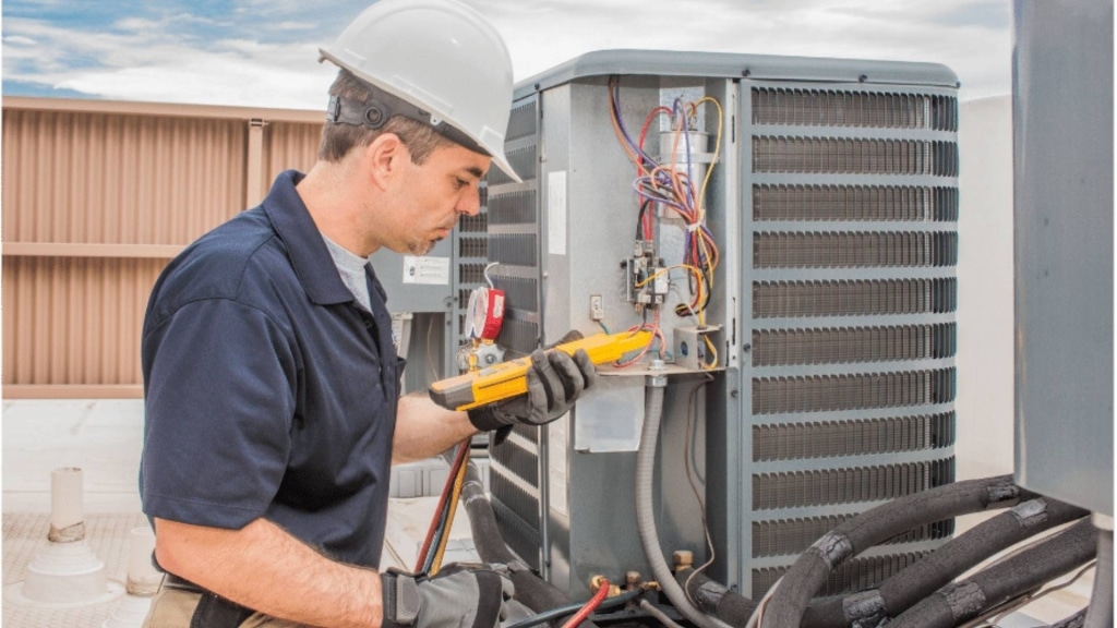 Technician repairing a furnace in Ozark, MO, ensuring efficient heating for a cozy home during winter.